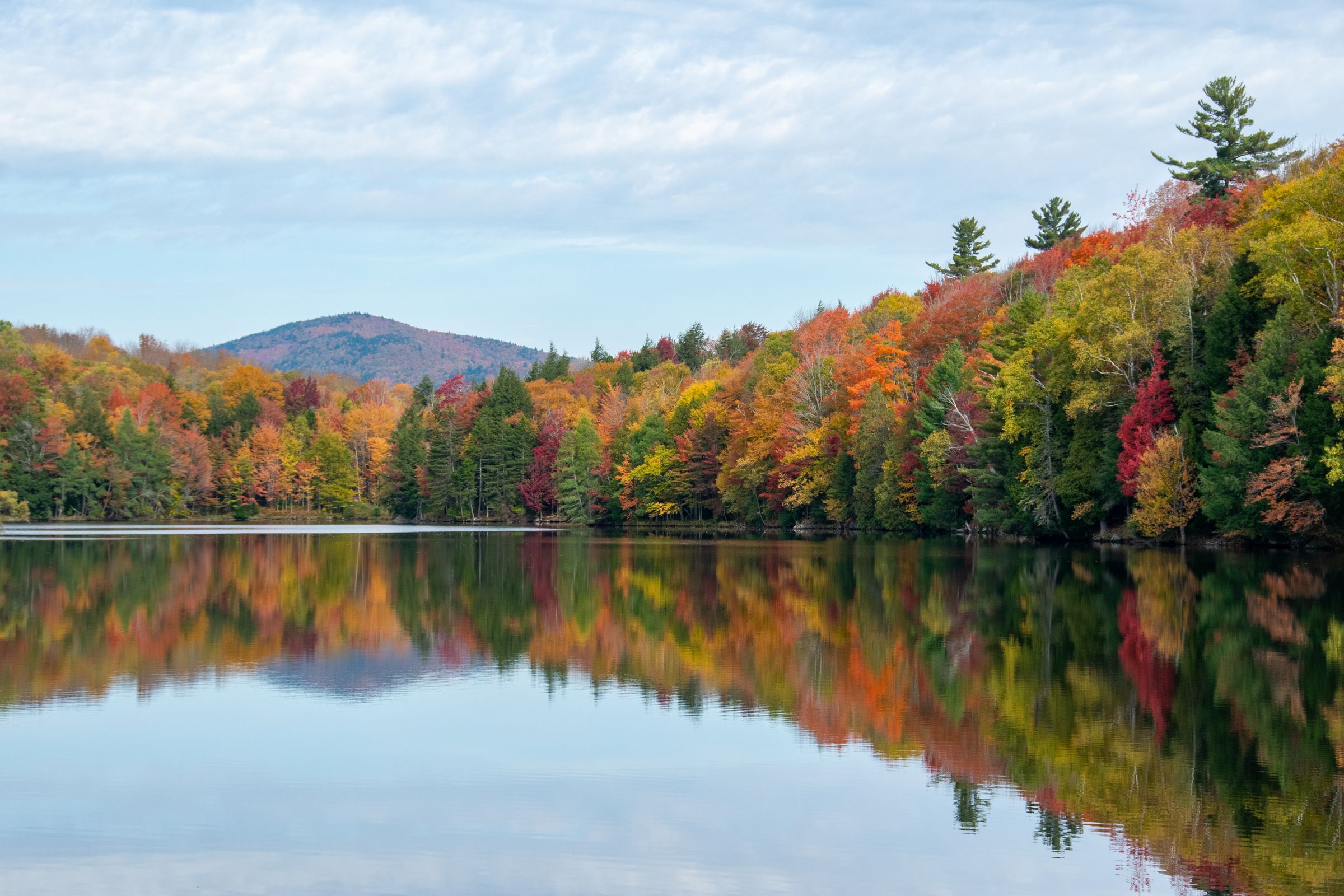 Vermont lake reflecting autumn foliage